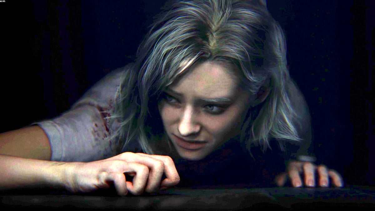 A woman is lying on the ground looking scared