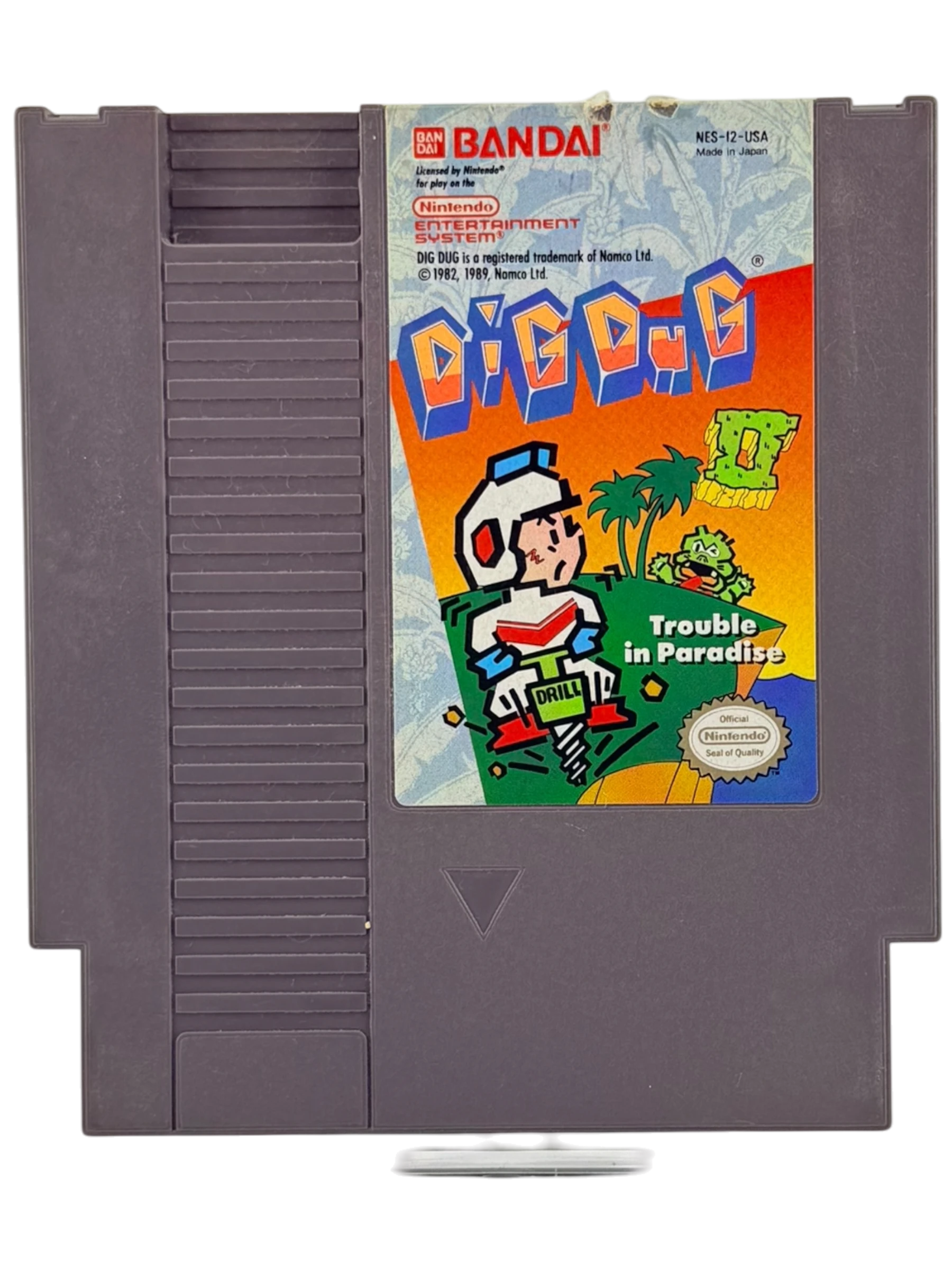 Coolection Dig Dug II: Trouble in Paradise NES cartridge. Features colorful artwork of the main character with a drill, tropical island, and enemies.
